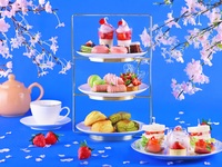 A luxurious afternoon tea featuring strawberries and cherry blossoms.