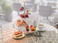 Strawberry afternoon tea with spring flowers fluttering about